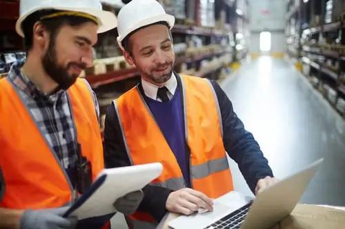 Two men working on supply chain management solutions.