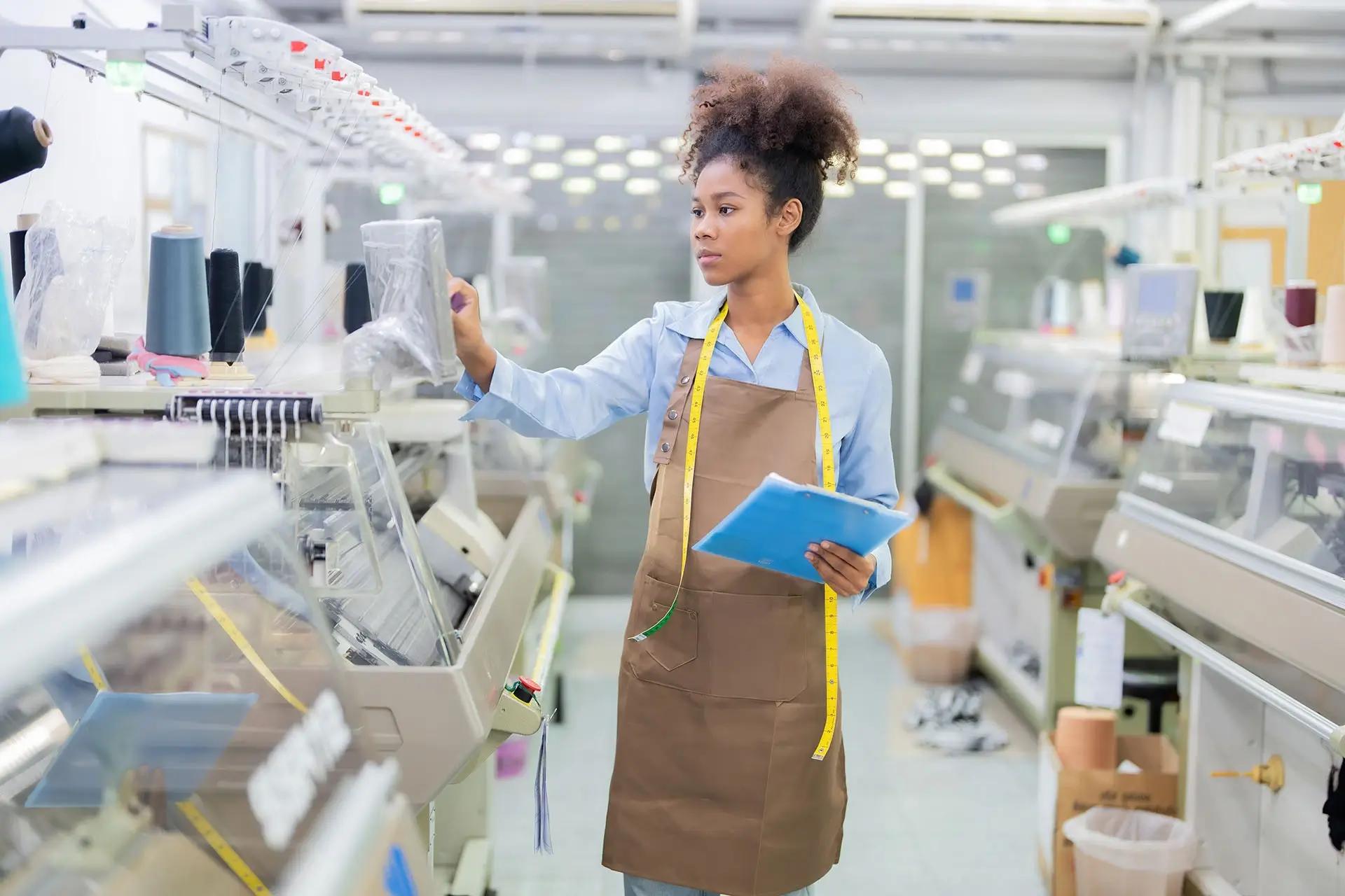 Female researcher inspecting the workplace, no doubt benefiting from returnable asset management solutions.