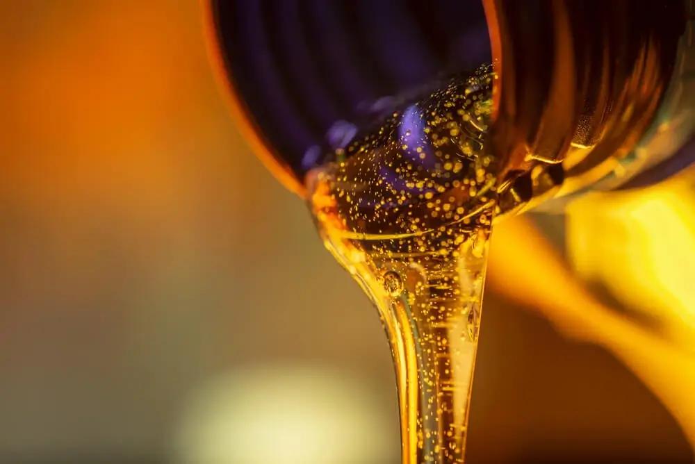 Used oil being poured out of a container in the context of supply chain management in the oil recycling industry.