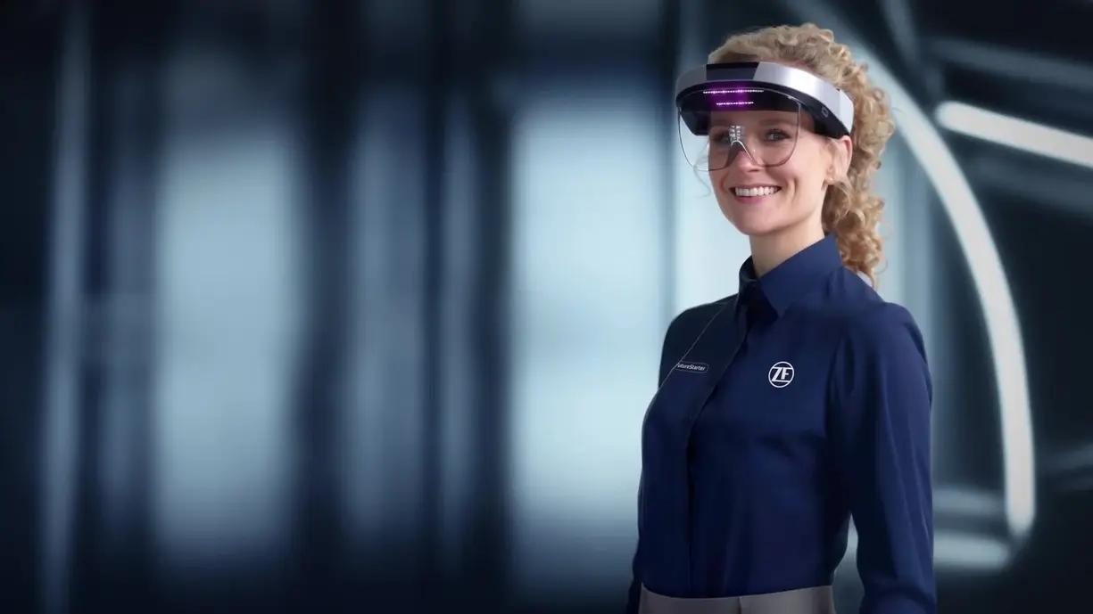 Smiling female ZF worker, thriving with cutting-edge supply chain tech innovations.